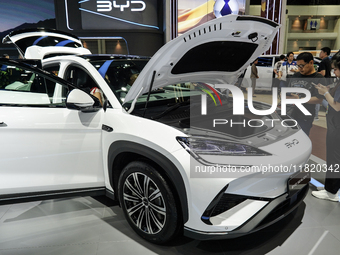 Visitors inspect a BYD SEALION 7 electric car displayed at the Thailand International Motor Expo 2024 at IMPACT exhibition center in Bangkok...