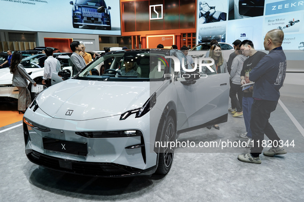 Visitors inspect a ZEEKR X electric car displayed at the Thailand International Motor Expo 2024 at the IMPACT exhibition center in Bangkok,...