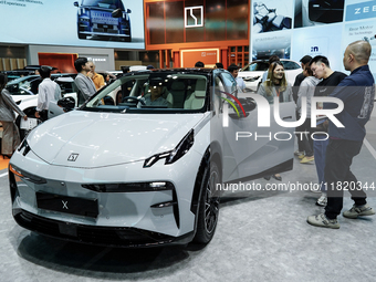 Visitors inspect a ZEEKR X electric car displayed at the Thailand International Motor Expo 2024 at the IMPACT exhibition center in Bangkok,...