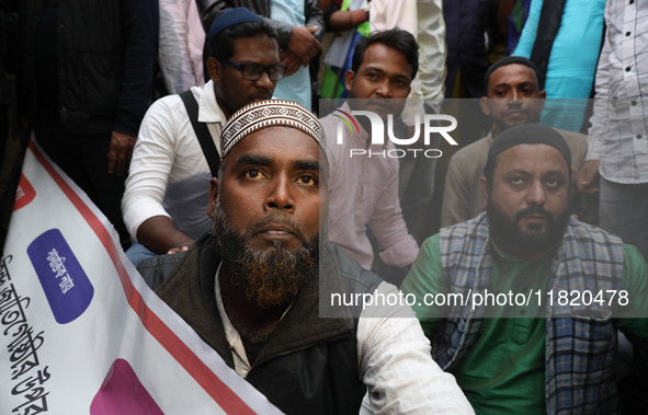 Police personnel block a road while supporters of the ISF (The Indian Secular Front) party shout slogans during a protest march towards the...