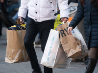 Shoppers carry Christmas shopping at the city center of Cologne, Germany, on November 29, 2024, during the Black Friday Sale. (