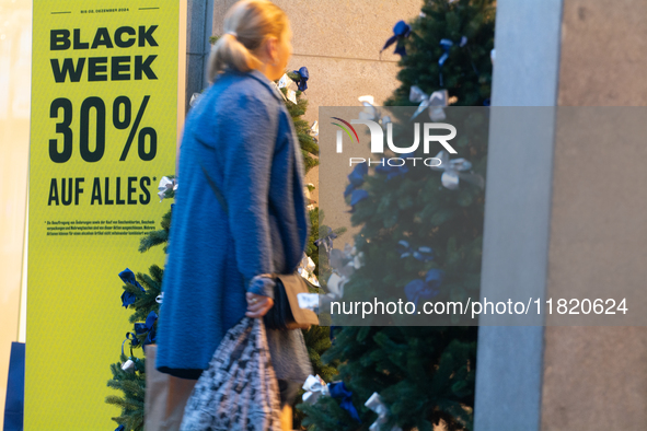 Shoppers enter a retailer shop at the city center of Cologne, Germany, on November 29, 2024, during the Black Friday Sale. 