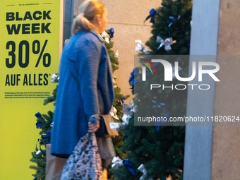 Shoppers enter a retailer shop at the city center of Cologne, Germany, on November 29, 2024, during the Black Friday Sale. (