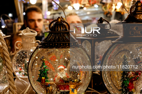 Visitors watch Christmas decorations as they walk the alleys of Krakow's Christmas Market, one of the largest such markets in Europe as it o...