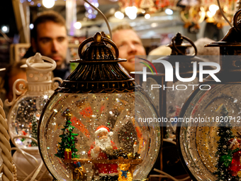 Visitors watch Christmas decorations as they walk the alleys of Krakow's Christmas Market, one of the largest such markets in Europe as it o...