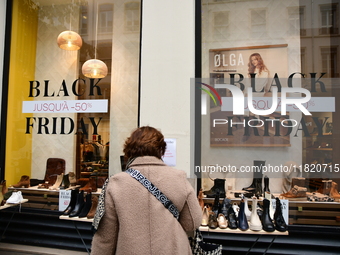 A person takes advantage of Black Friday in a shoe store in Lyon, France, on November 29, 2024. (