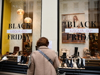 A person takes advantage of Black Friday in a shoe store in Lyon, France, on November 29, 2024. (