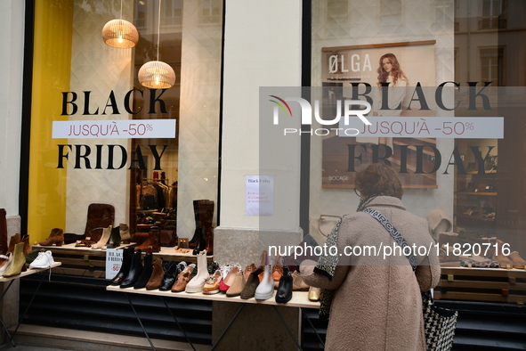 A person takes advantage of Black Friday in a shoe store in Lyon, France, on November 29, 2024. 