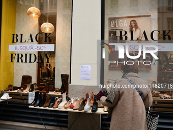 A person takes advantage of Black Friday in a shoe store in Lyon, France, on November 29, 2024. (