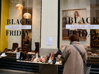 A person takes advantage of Black Friday in a shoe store in Lyon, France, on November 29, 2024. (