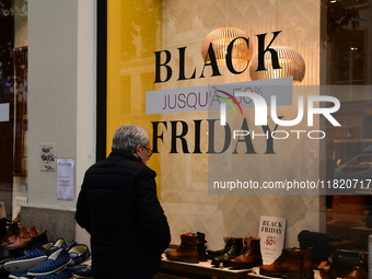 A person takes advantage of Black Friday in a shoe store in Lyon, France, on November 29, 2024. (