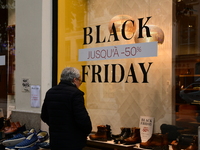 A person takes advantage of Black Friday in a shoe store in Lyon, France, on November 29, 2024. (