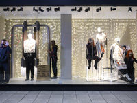 Climate activists with their hands glued to a shop window take part in a protest against fast fashion in Warsaw, Poland, on November 29, 202...