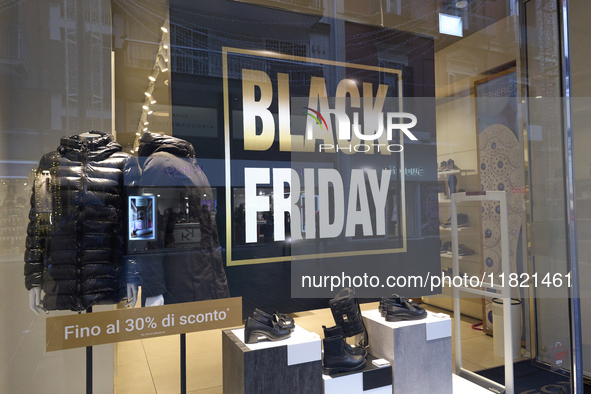 Promotional signage advertises up to 70% off for Black Friday at a clothing store in Bari, Italy, on November 29, 2024. The image highlights...