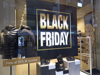 Promotional signage advertises up to 70% off for Black Friday at a clothing store in Bari, Italy, on November 29, 2024. The image highlights...