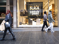 Promotional signage advertises up to 70% off for Black Friday at a clothing store in Bari, Italy, on November 29, 2024. The image highlights...