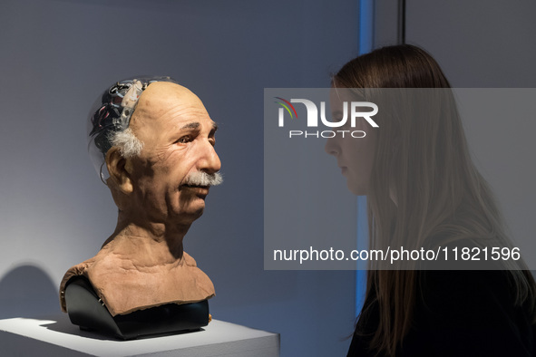 LONDON, UNITED KINGDOM - NOVEMBER 29, 2024: A staff member looks at The Einstein robotic head, developed by Hanson Robotics in 2005: a landm...