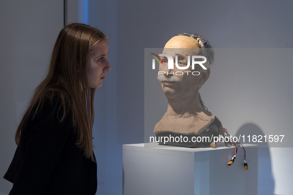 LONDON, UNITED KINGDOM - NOVEMBER 29, 2024: A staff member looks at The Einstein robotic head, developed by Hanson Robotics in 2005: a landm...