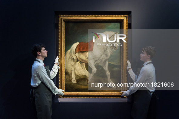 LONDON, UNITED KINGDOM - NOVEMBER 29, 2024: Art handlers hold a painting by Anthony van Dyck 'An Andalusian Horse' - his first grand-scale d...