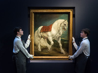 LONDON, UNITED KINGDOM - NOVEMBER 29, 2024: Art handlers hold a painting by Anthony van Dyck 'An Andalusian Horse' - his first grand-scale d...