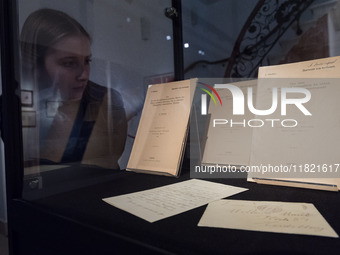 LONDON, UNITED KINGDOM - NOVEMBER 29, 2024: A staff member looks at exceptionally rare first edition, author's offprint issues, of Einstein'...