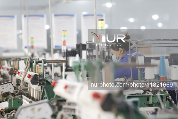 Workers work at a production workshop of a textile enterprise in Sihong Economic Development Zone in Suqian, Jiangsu province, China, on Nov...