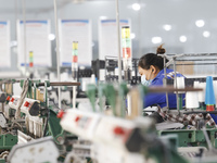 Workers work at a production workshop of a textile enterprise in Sihong Economic Development Zone in Suqian, Jiangsu province, China, on Nov...