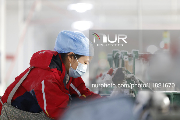 Workers work at a production workshop of a textile enterprise in Sihong Economic Development Zone in Suqian, Jiangsu province, China, on Nov...