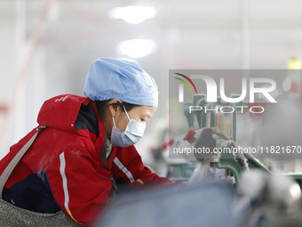 Workers work at a production workshop of a textile enterprise in Sihong Economic Development Zone in Suqian, Jiangsu province, China, on Nov...