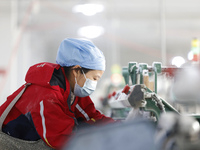 Workers work at a production workshop of a textile enterprise in Sihong Economic Development Zone in Suqian, Jiangsu province, China, on Nov...