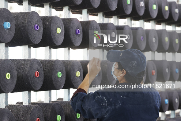 Workers work at a production workshop of a textile enterprise in Sihong Economic Development Zone in Suqian, Jiangsu province, China, on Nov...