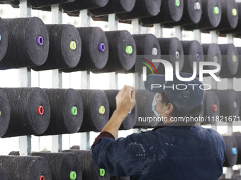 Workers work at a production workshop of a textile enterprise in Sihong Economic Development Zone in Suqian, Jiangsu province, China, on Nov...