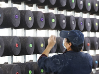 Workers work at a production workshop of a textile enterprise in Sihong Economic Development Zone in Suqian, Jiangsu province, China, on Nov...