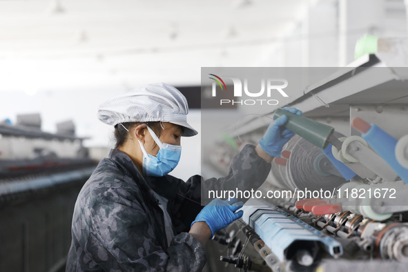 Workers work at a production workshop of a textile enterprise in Sihong Economic Development Zone in Suqian, Jiangsu province, China, on Nov...