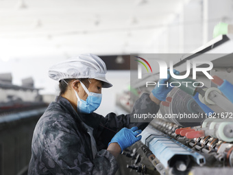 Workers work at a production workshop of a textile enterprise in Sihong Economic Development Zone in Suqian, Jiangsu province, China, on Nov...