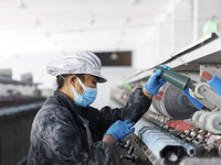 Workers work at a production workshop of a textile enterprise in Sihong Economic Development Zone in Suqian, Jiangsu province, China, on Nov...