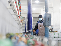 Workers work at a production workshop of a textile enterprise in Sihong Economic Development Zone in Suqian, Jiangsu province, China, on Nov...