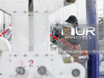 Workers work at a production workshop of a textile enterprise in Sihong Economic Development Zone in Suqian, Jiangsu province, China, on Nov...