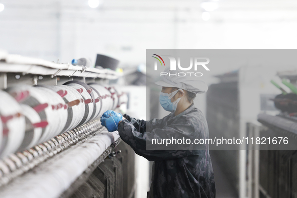 Workers work at a production workshop of a textile enterprise in Sihong Economic Development Zone in Suqian, Jiangsu province, China, on Nov...