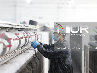 Workers work at a production workshop of a textile enterprise in Sihong Economic Development Zone in Suqian, Jiangsu province, China, on Nov...