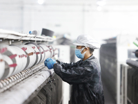 Workers work at a production workshop of a textile enterprise in Sihong Economic Development Zone in Suqian, Jiangsu province, China, on Nov...