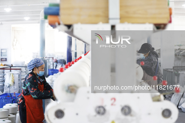 Workers work at a production workshop of a textile enterprise in Sihong Economic Development Zone in Suqian, Jiangsu province, China, on Nov...