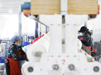 Workers work at a production workshop of a textile enterprise in Sihong Economic Development Zone in Suqian, Jiangsu province, China, on Nov...