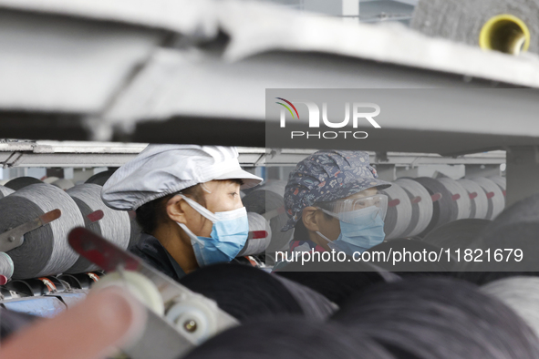 Workers work at a production workshop of a textile enterprise in Sihong Economic Development Zone in Suqian, Jiangsu province, China, on Nov...