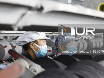 Workers work at a production workshop of a textile enterprise in Sihong Economic Development Zone in Suqian, Jiangsu province, China, on Nov...