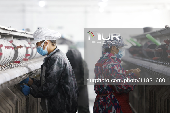 Workers work at a production workshop of a textile enterprise in Sihong Economic Development Zone in Suqian, Jiangsu province, China, on Nov...