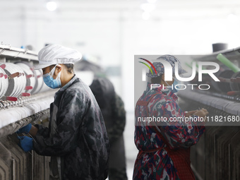 Workers work at a production workshop of a textile enterprise in Sihong Economic Development Zone in Suqian, Jiangsu province, China, on Nov...