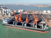 Cranes unload coal from cargo ships at Longkou port area of Yantai Port in East China's Shandong province on November 29, 2024. (