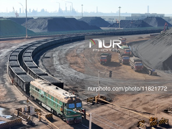 The coal transport train departs from the coal yard in Longkou Port Area, Yantai City, Shandong Province, China, on November 29, 2024. 