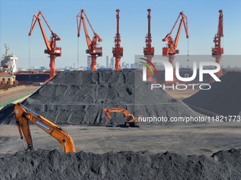 Loading machinery operates at the coal yard in Longkou Port Area, Yantai City, Shandong Province, China, on November 29, 2024. (